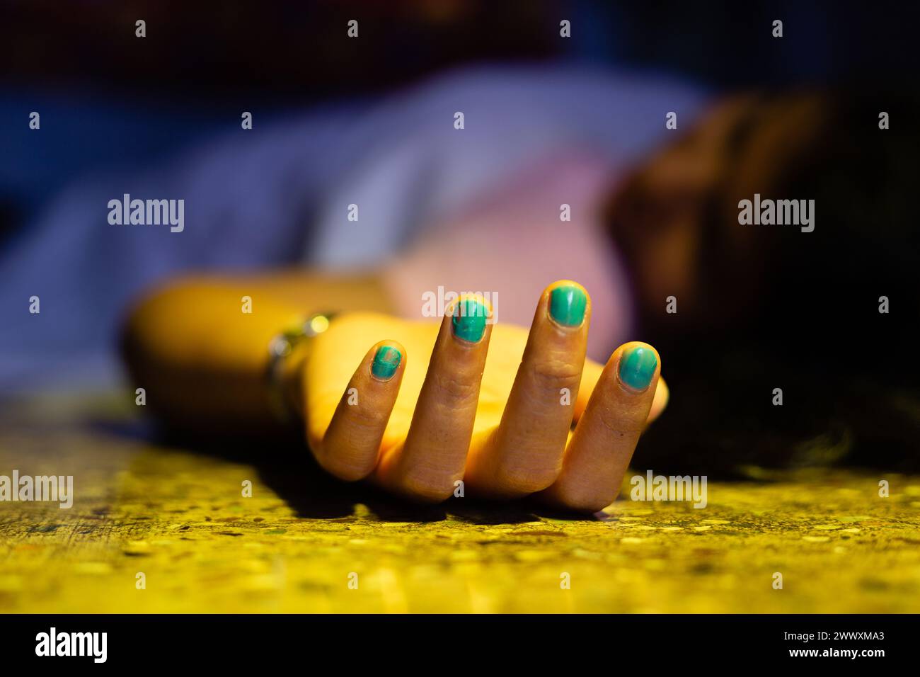 An Indian or Asian woman dead body with outstretched hand lying on