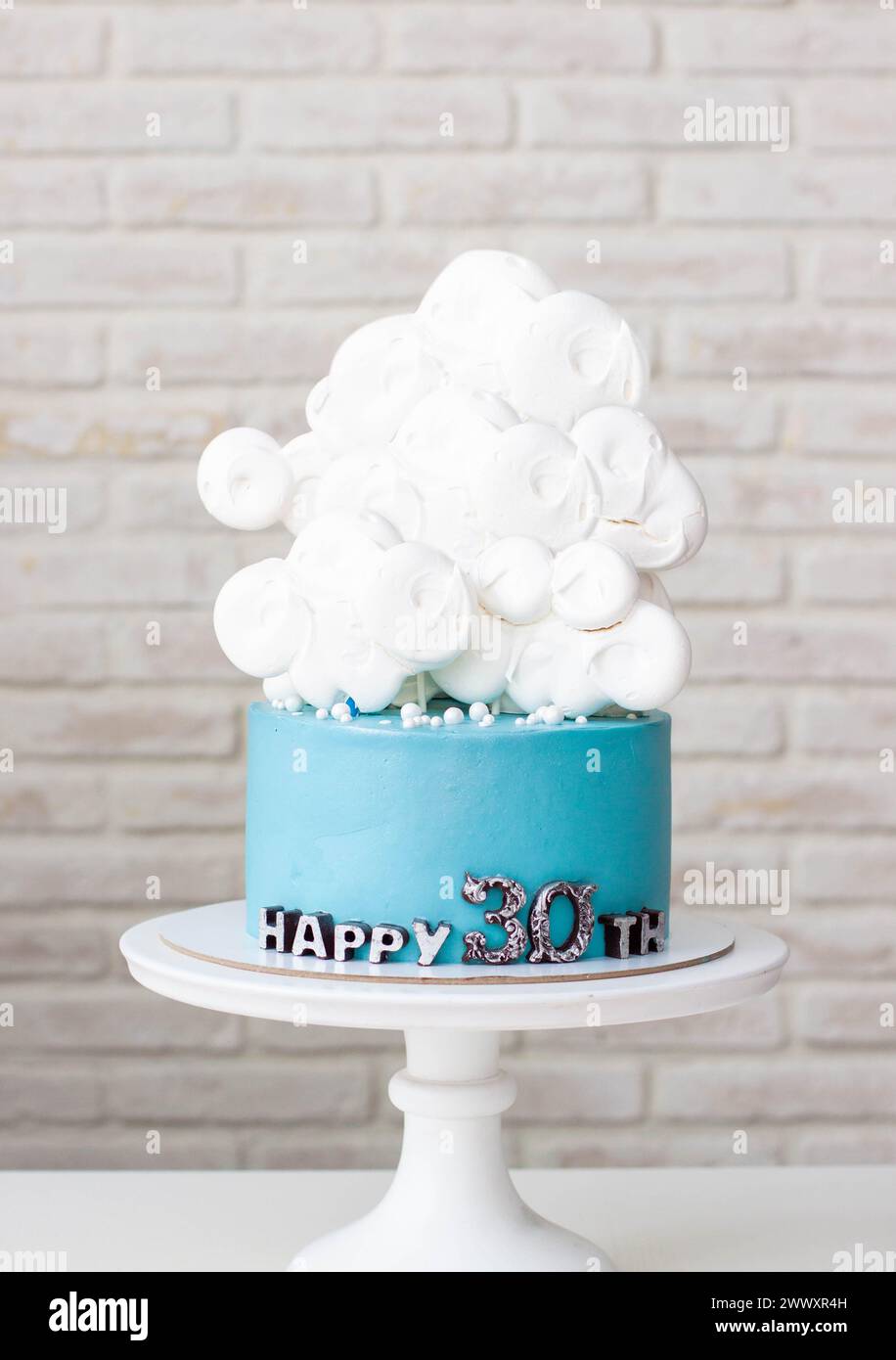 Blue birthday cake with white clouds for 30th anniversary on neutral background Stock Photo