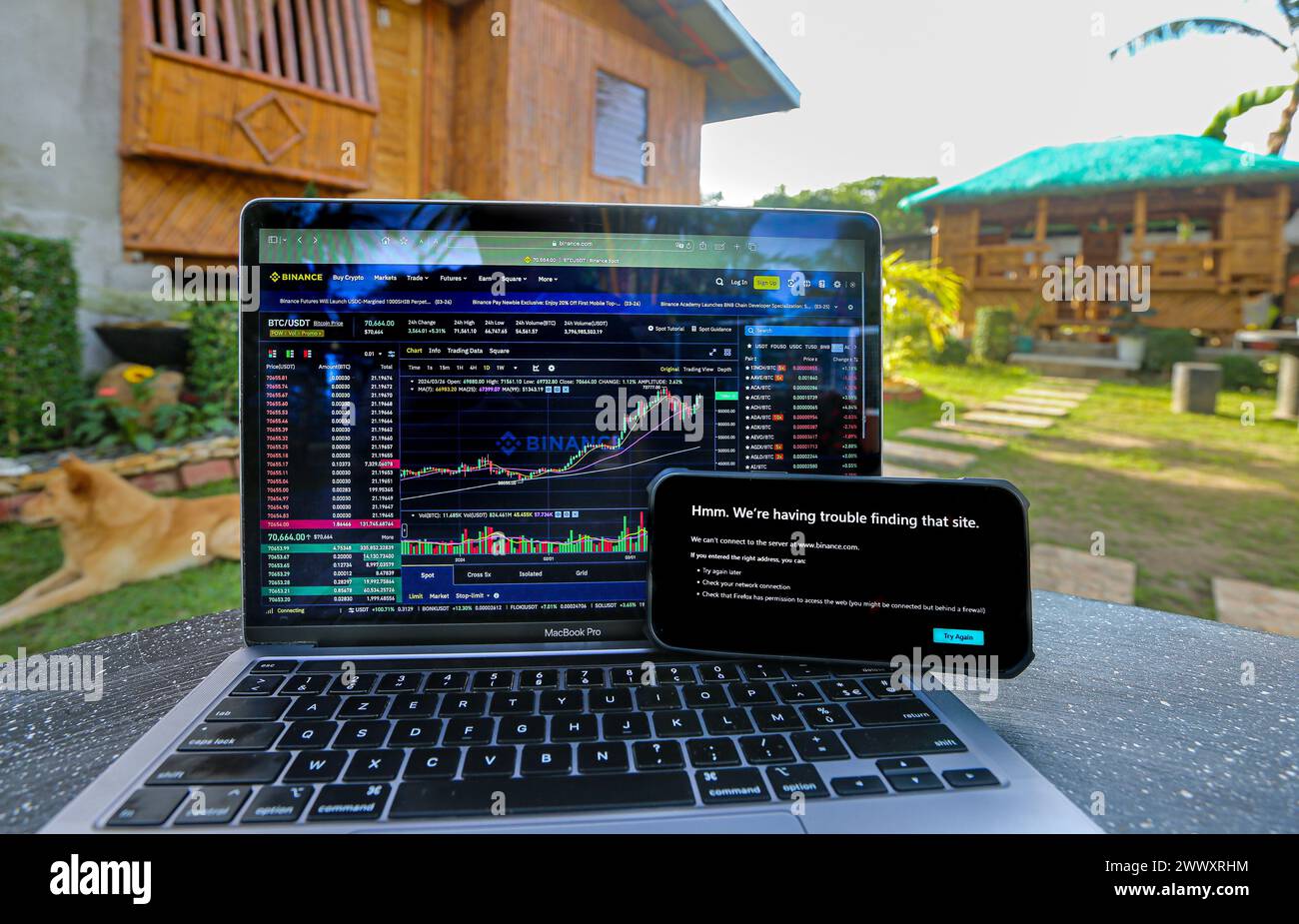 Manila, Philippines. Mar 26, 2024: Binance website still accessible on laptop with telecommunications operator Converge but already banned by its competitor PLDT on smartphone, in front of traditional Filipino bamboo house 'Bahay Kubo'. Securities & Exchange Commission (SEC) ordered Philippine internet service providers to block cryptocurrency giant Binance.com. In 2017, Duterte admin had issued similar ban order regarding popular adult websites. A censorship which didn't have expected result: since then, using VPN, the PH is always in Pornhub top countries.Credit: Kevin Izorce/Alamy Live News Stock Photo