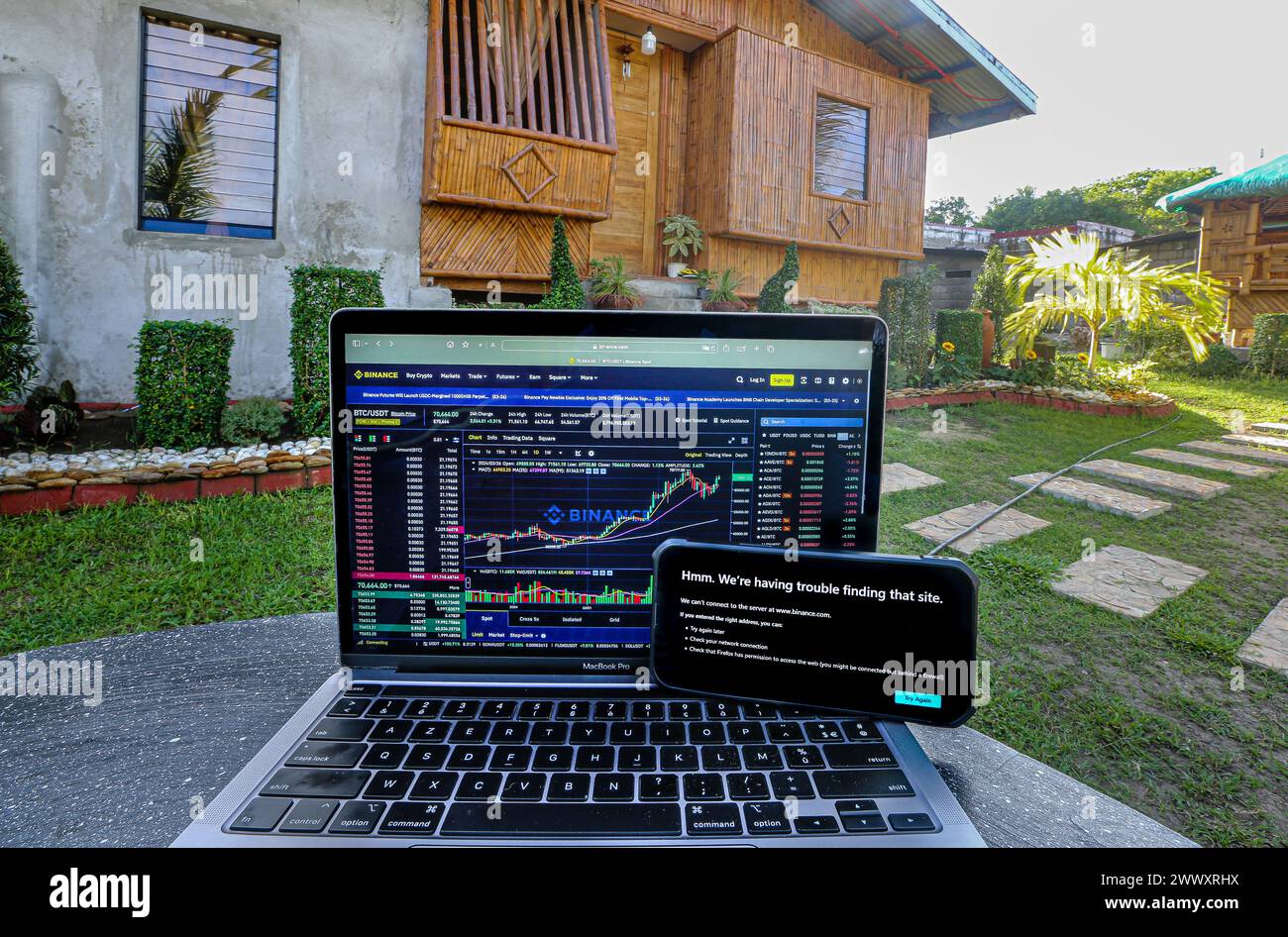 Manila, Philippines. Mar 26, 2024: Binance website still accessible on laptop with telecommunications operator Converge but already banned by its competitor PLDT on smartphone, in front of traditional Filipino bamboo house 'Bahay Kubo'. Securities & Exchange Commission (SEC) ordered Philippine internet service providers to block cryptocurrency giant Binance.com. In 2017, Duterte admin had issued similar ban order regarding popular adult websites. A censorship which didn't have expected result: since then, using VPN, the PH is always in Pornhub top countries.Credit: Kevin Izorce/Alamy Live News Stock Photo