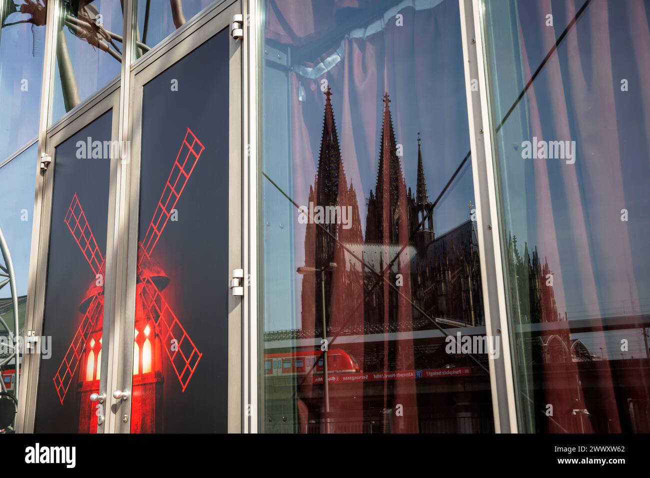 the cathedral is reflected in a window of the tent theater Musical Dome where Moulin Rouge is currently being performed, Cologne, Germany. der Dom spi Stock Photo