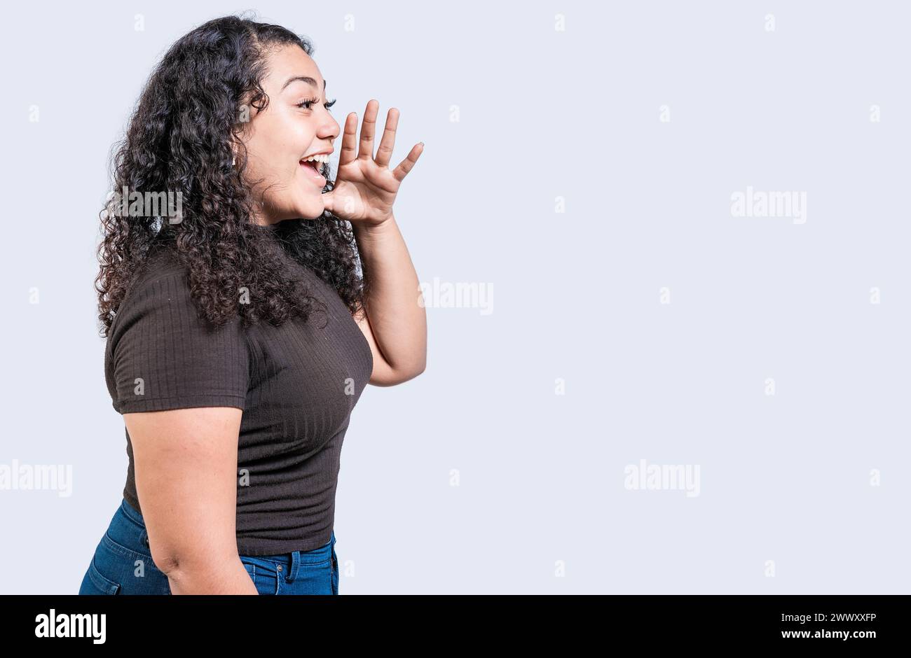 Happy girl announcing something isolated. Beautiful woman screaming and announcing an advertising isolated Stock Photo