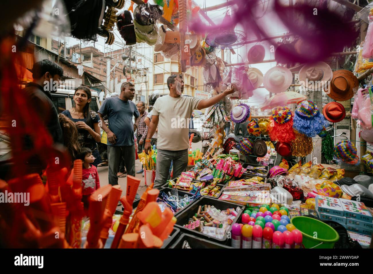 Vendor sells Holi celebration items in a street market, ahead of Holi festival on March 23, 2024 in Guwahati, Assam, India. Holi is the Hindu Stock Photo