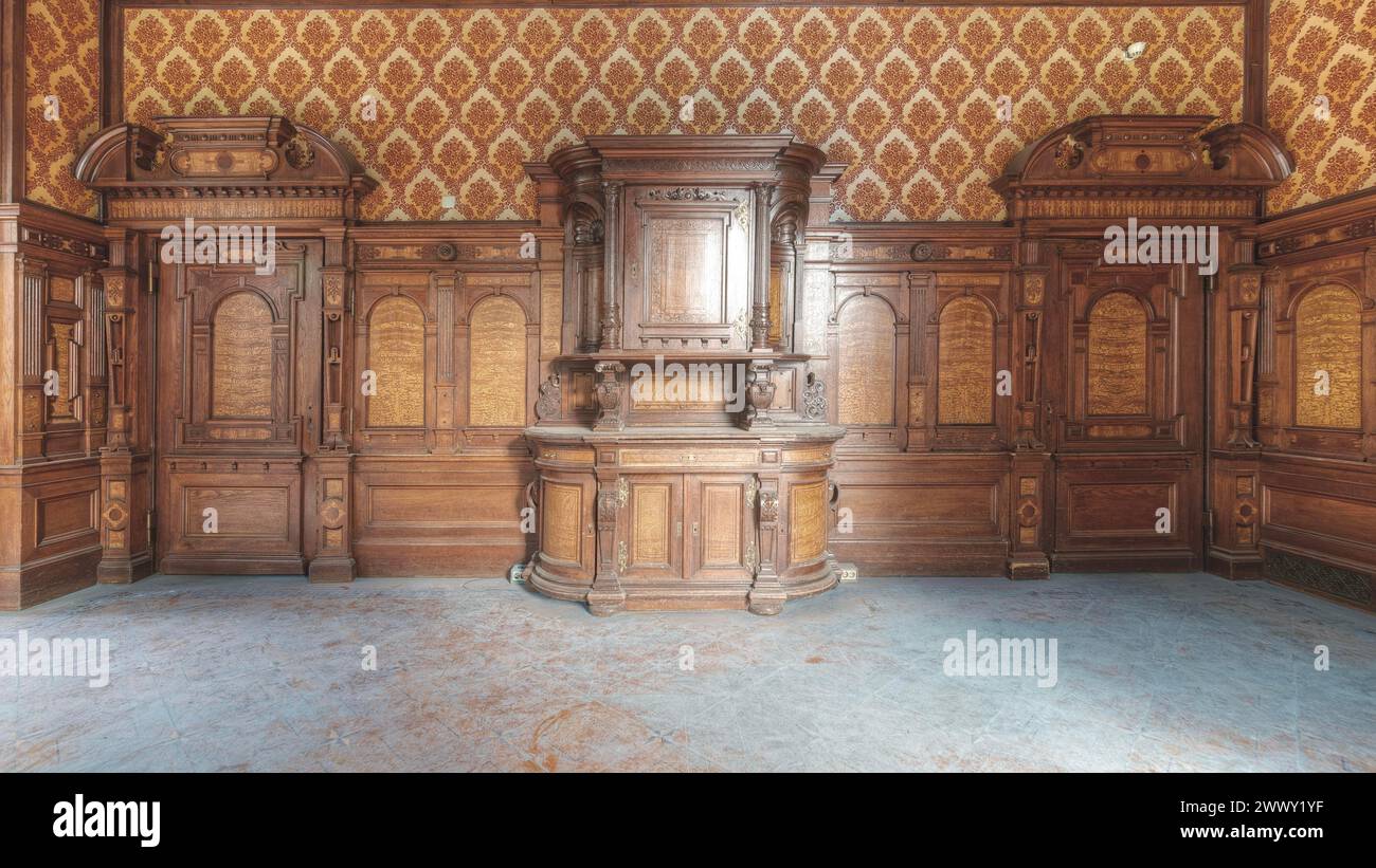 Detailed wooden cabinet in front of ornamental wall panelling in a historic room, Villa Woodstock, Lost Place, Brill, Wuppertal, North Stock Photo
