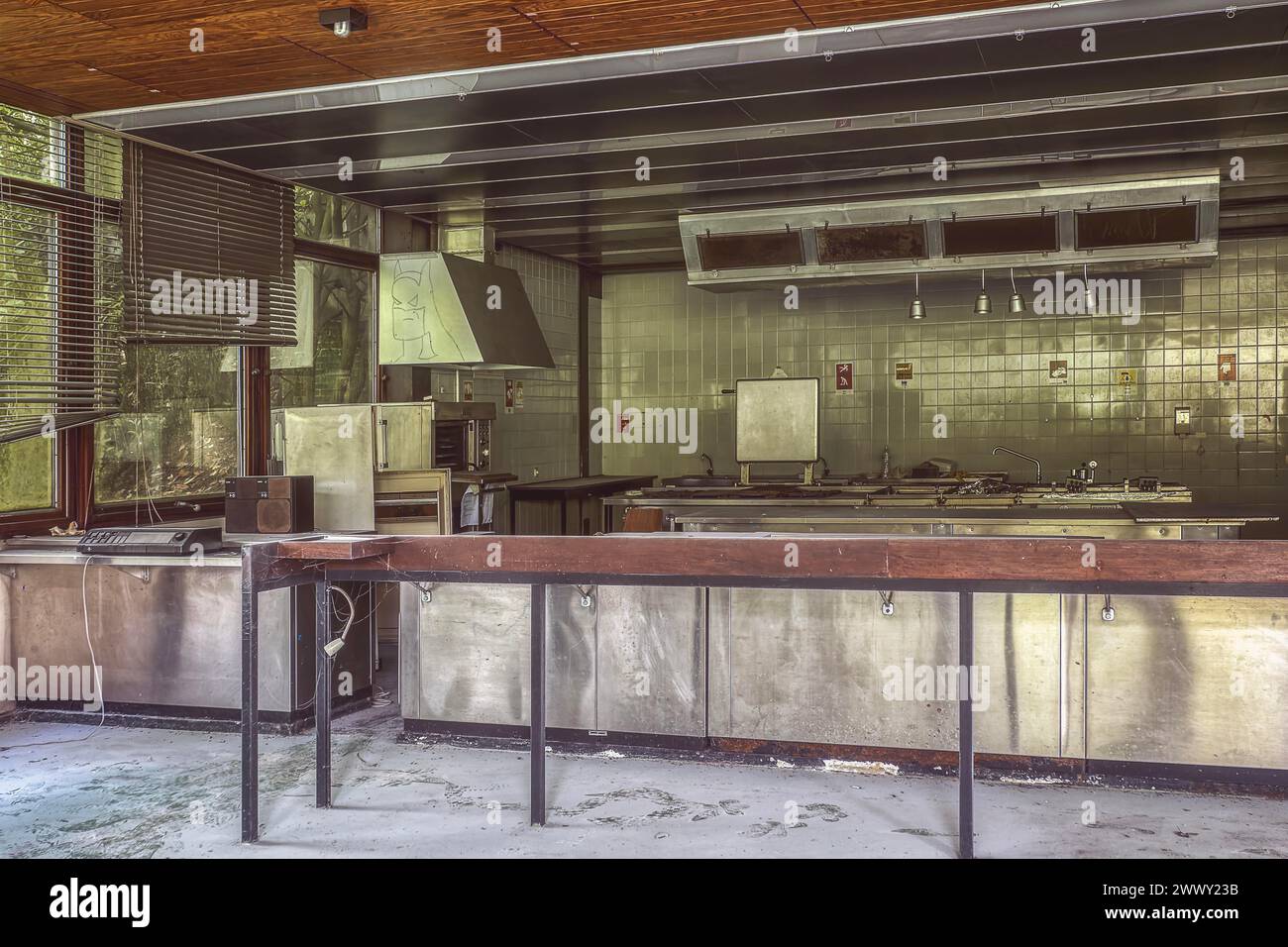 An abandoned, dust-covered industrial kitchen with stainless steel surfaces and tiled backsplash, Institute of Molecular Biology, Lost Place Stock Photo