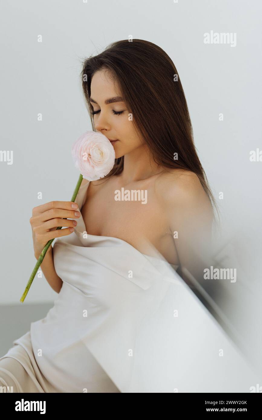 beautiful young woman posing with orchid Stock Photo