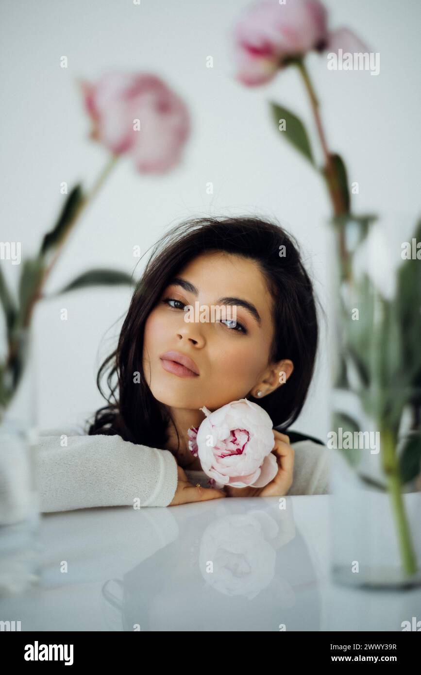 Beautiful young woman with delicate peony flower. Girl clean fresh skin . Facial treatment . Cosmetology , beauty and spa . Face care Stock Photo