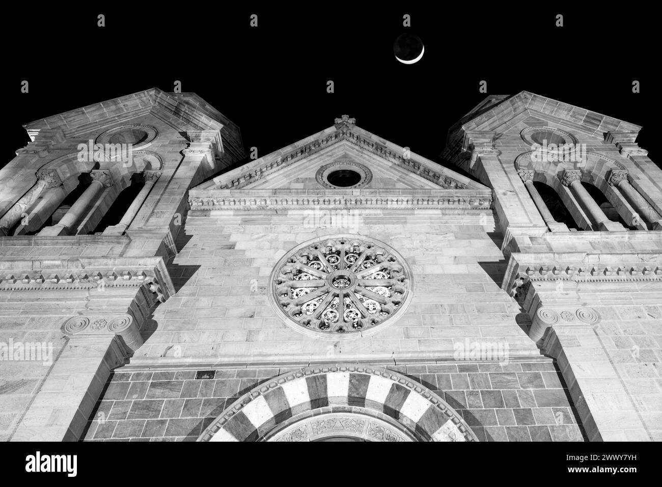 NM00654-00-BW.....NEW MEXICO - Cathedral Basillica Of St Francis in Santa Fe at night with crescent moon. Stock Photo