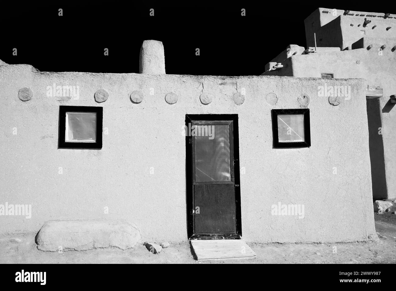 NM00687-00-BW....NEW MEXICO - North House, with door and two windows, Taos Pueblo tribal land. Stock Photo