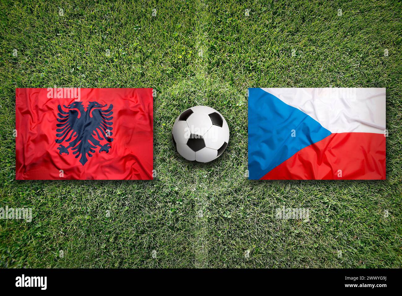 Albania vs. Czech Republic flags on green soccer field Stock Photo