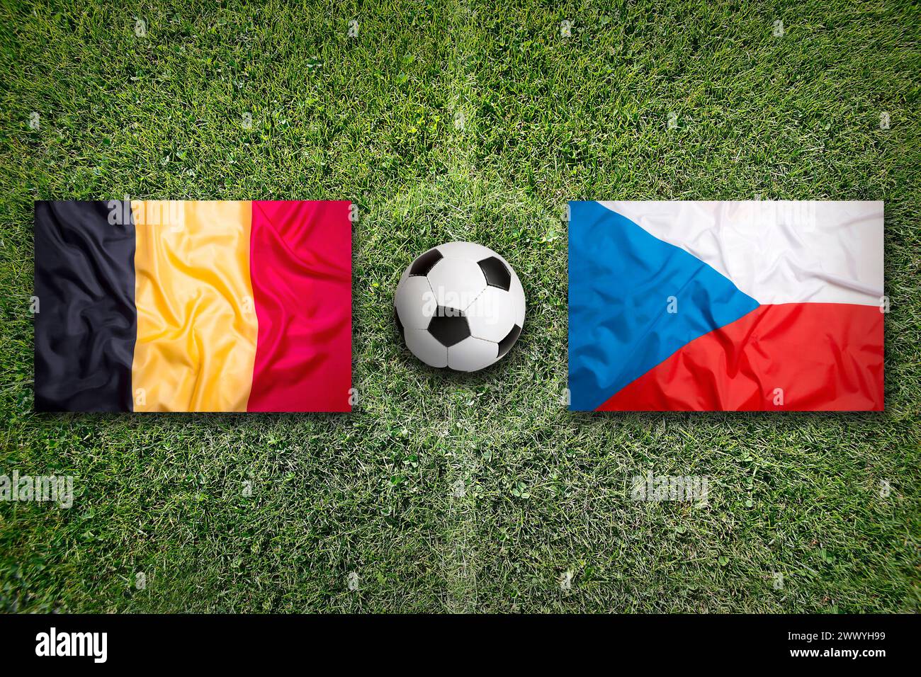 Belgium vs. Czech Republic flags on green soccer field Stock Photo