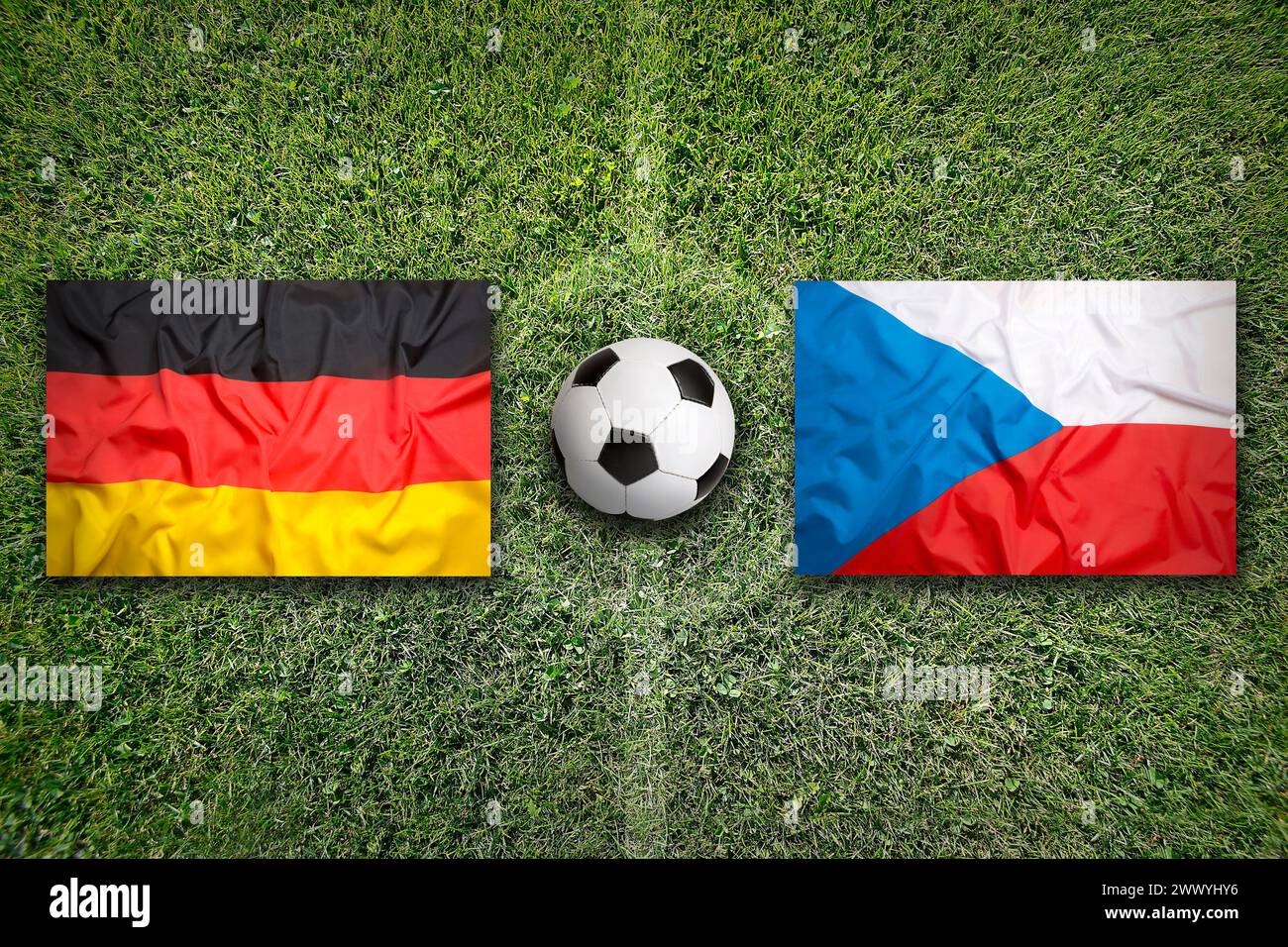 Germany vs. Czech Republic flags on green soccer field Stock Photo