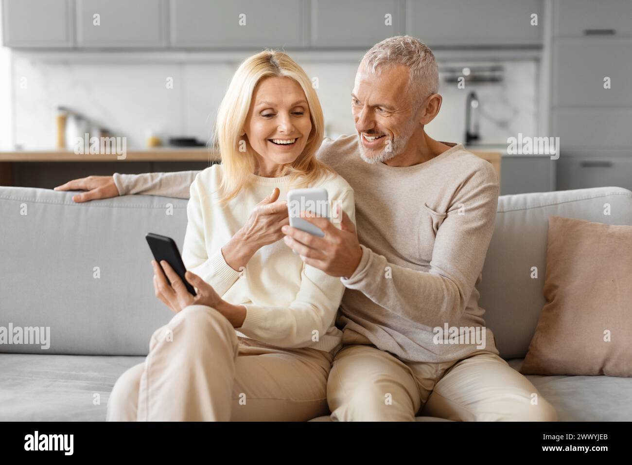 Happy senior couple using smartphone Stock Photo