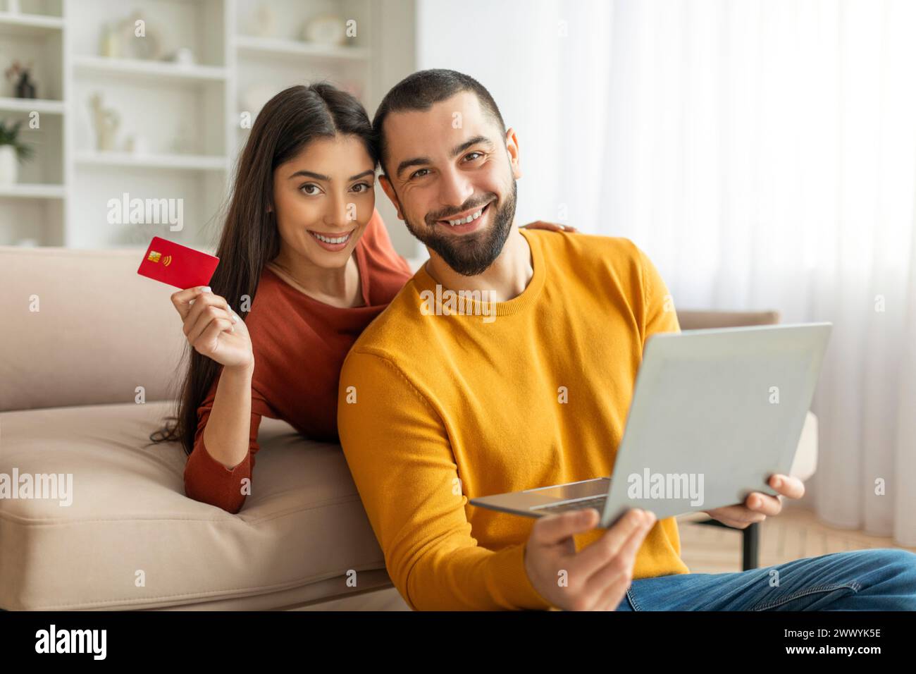Couple with credit card shopping online Stock Photo