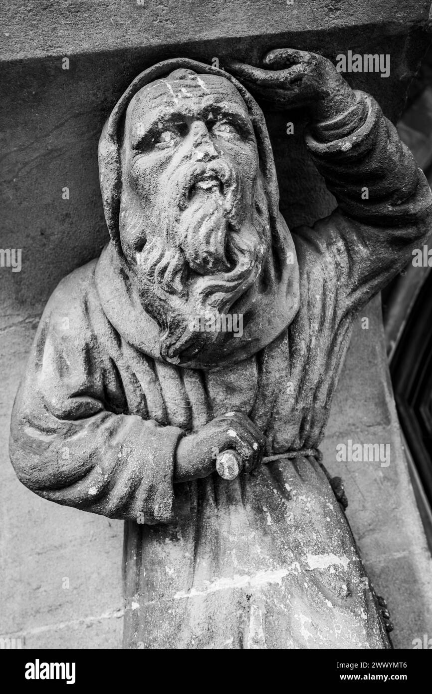 Victorian Gothic Door decoration of a carved stone monk. Weathered statue. Black and White image. Cardiff. Wales, UK Stock Photo