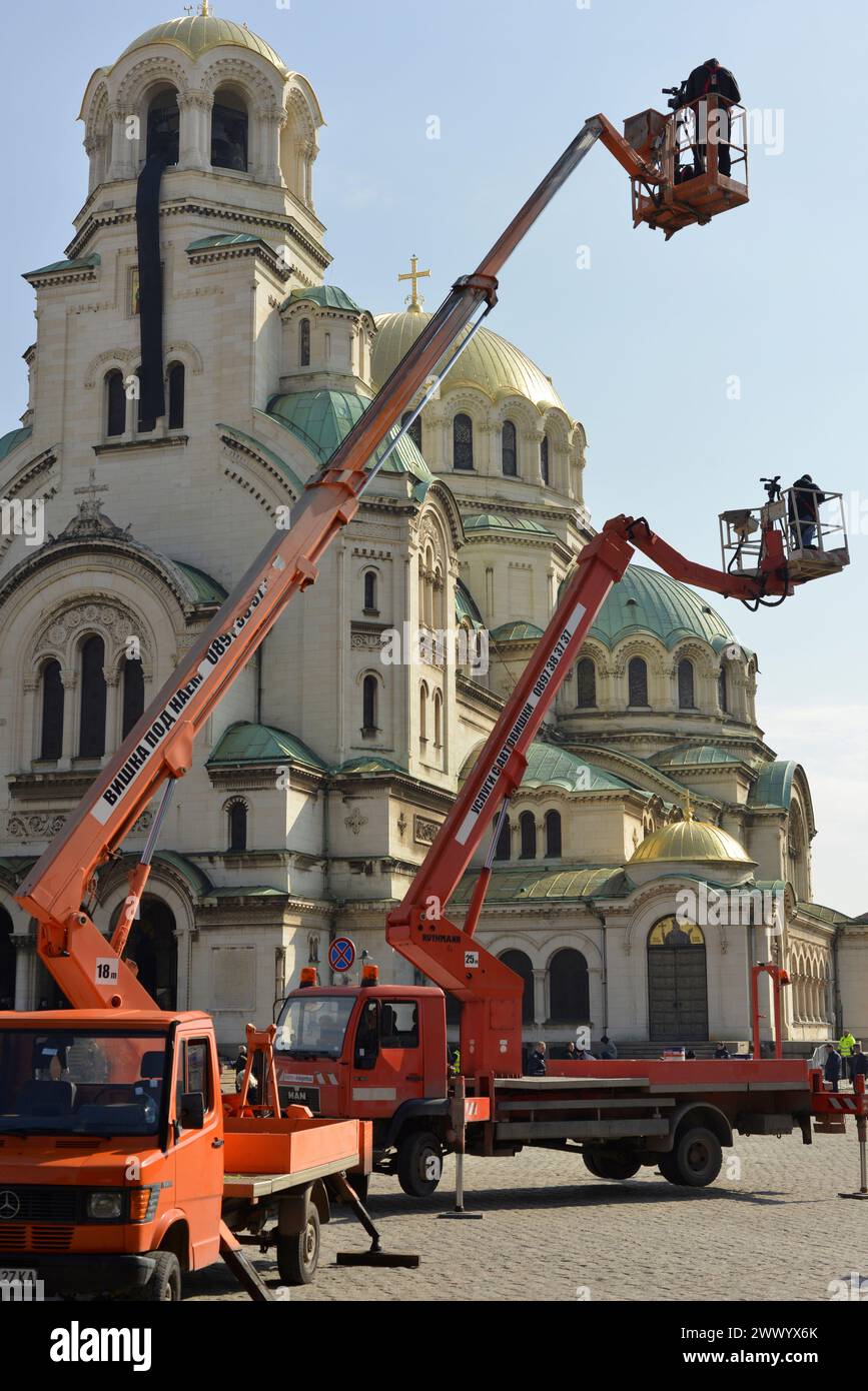 Bucket trucks with cameramen at St. Alexander Nevsky Cathedral for live coverage of the funeral of Patriarch Neophyte in Sofia, Bulgaria March 2024 Stock Photo