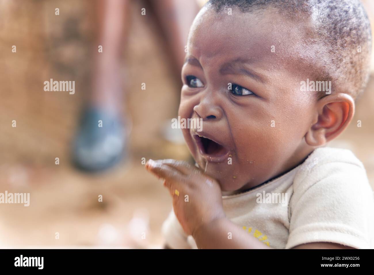 african child crying, toddler in distress, child protection services worldwide Stock Photo