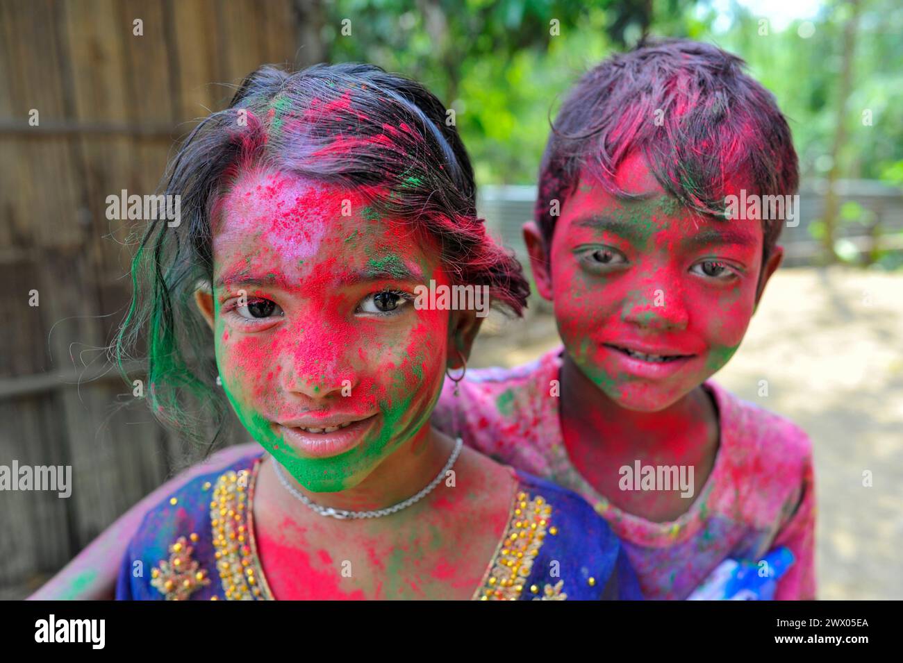 26 March 2024 Sylhet - Bangladesh: Children at a tea garden with painted faces in rainbow colours celebrating the annual Hindu festival of colors, known as Holi festival, marking the onset of spring. On 26 March 2024 Sylhet, Bangladesh (Credit Image: © Md Rafayat Haque Khan/eyepix via ZUMA Press Wire) EDITORIAL USAGE ONLY! Not for Commercial USAGE! Stock Photo