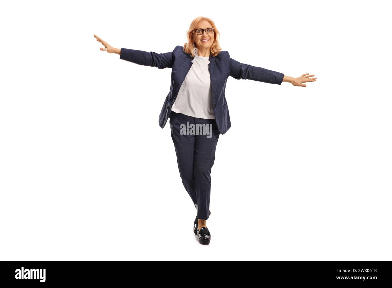 Full length portrait of a middle aged businesswoman walking on tiptoes