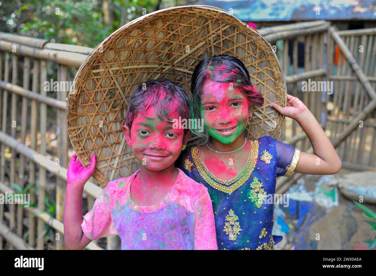 Non Exclusive: March 26, 2024, Sylhet, Bangladesh: Children  portrait with their faces painted  with colored powder celebrating the annual Hindu festi Stock Photo