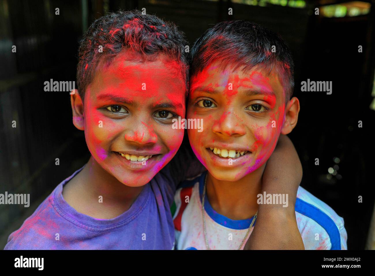 Non Exclusive: March 26, 2024, Sylhet, Bangladesh: Children at a tea garden with colorful painted their faces celebrating the annual Hindu festival of Stock Photo