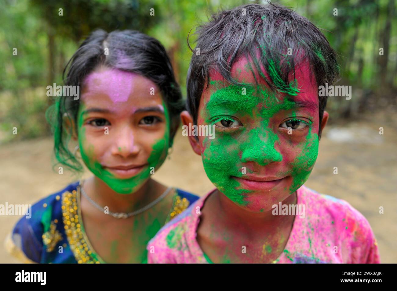 Non Exclusive: March 26, 2024, Sylhet, Bangladesh: Children  portrait with their faces painted  with colored powder celebrating the annual Hindu festi Stock Photo
