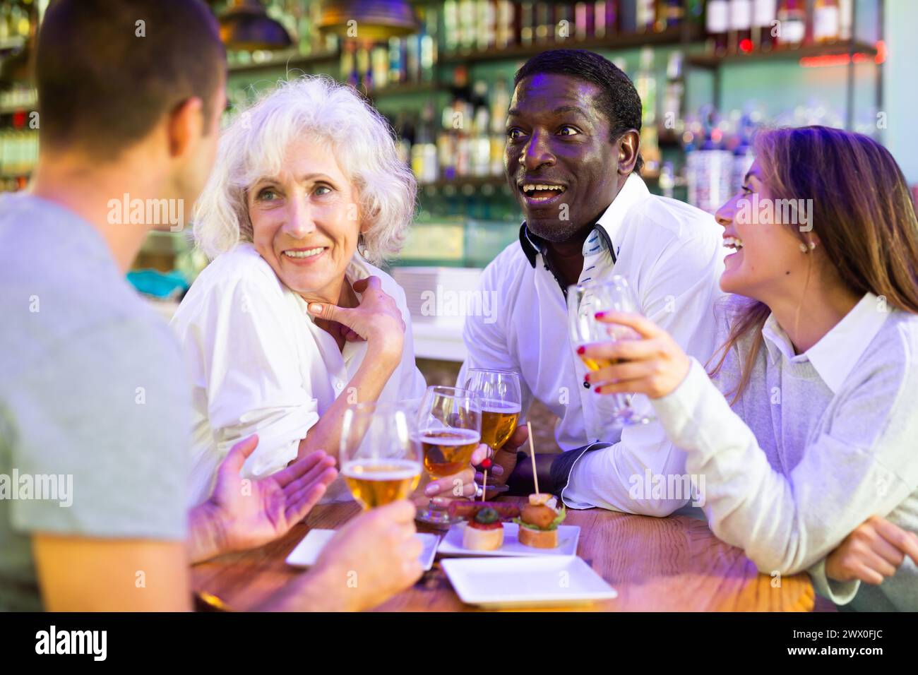 Group of happy friends having fun at celebration party in pub. Focus on ...