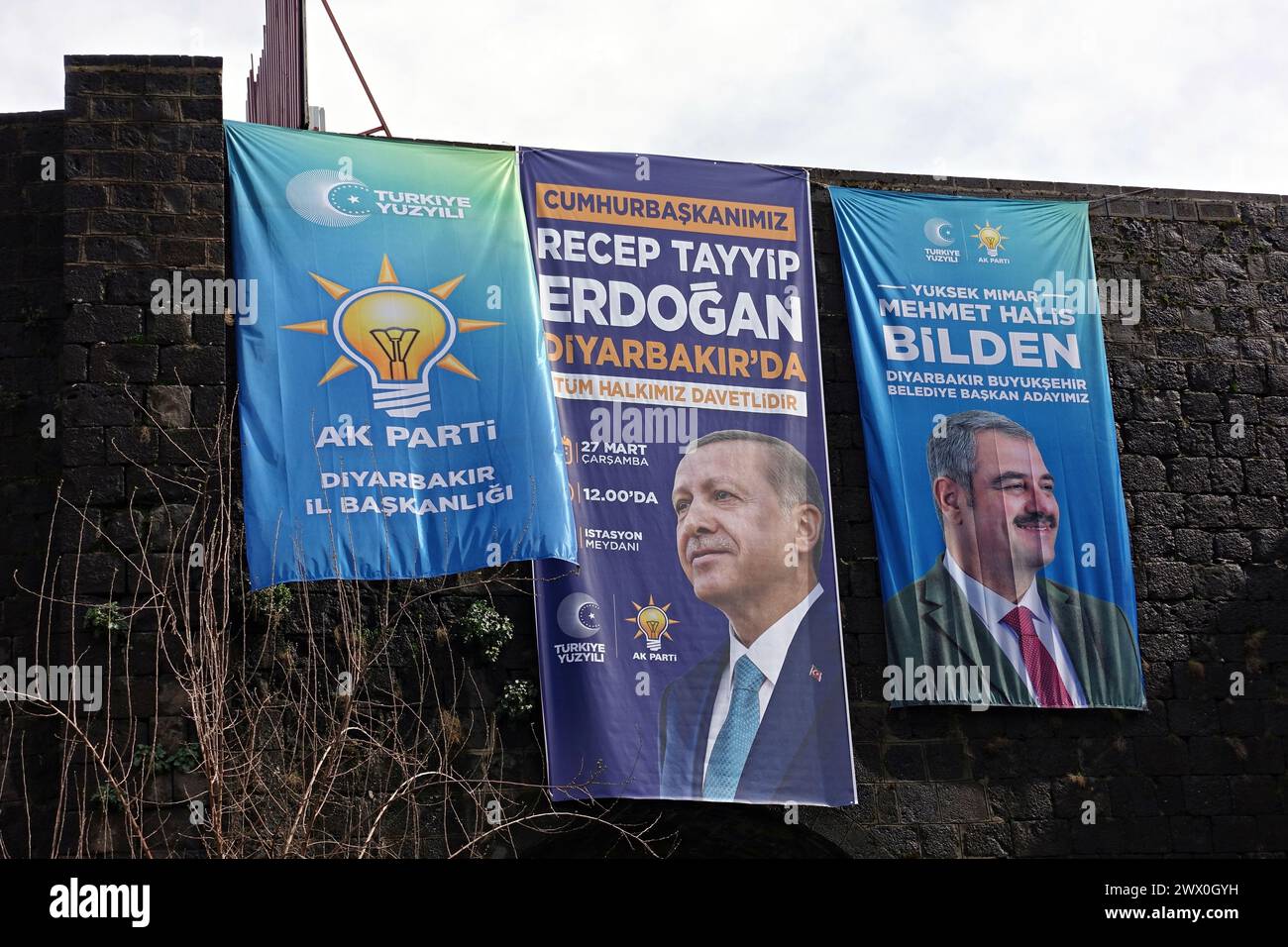 Diyarbakir, Turkey. 26th Mar, 2024. The election posters and party flag of Recep Tayyip Erdogan, President of Turkey and Chairman of the Justice and Development Party (AK Party), are seen hanging on the historical walls in Diyarbakir. Political parties in Diyarbakir, the largest city in the region where Kurds live heavily in Turkey, are preparing for the municipal elections to be held across Turkey on March 31. Party flags seen hunging in the streets of Diyarbak?r, and propaganda posters seen on billboards. Credit: SOPA Images Limited/Alamy Live News Stock Photo