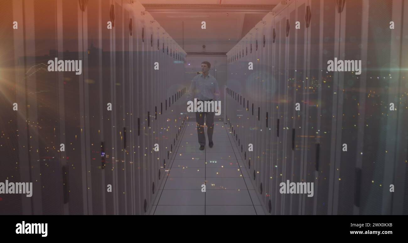 Composite image of caucasian male engineer walking in server room against night city traffic. Global networking and business storage technology concep Stock Photo