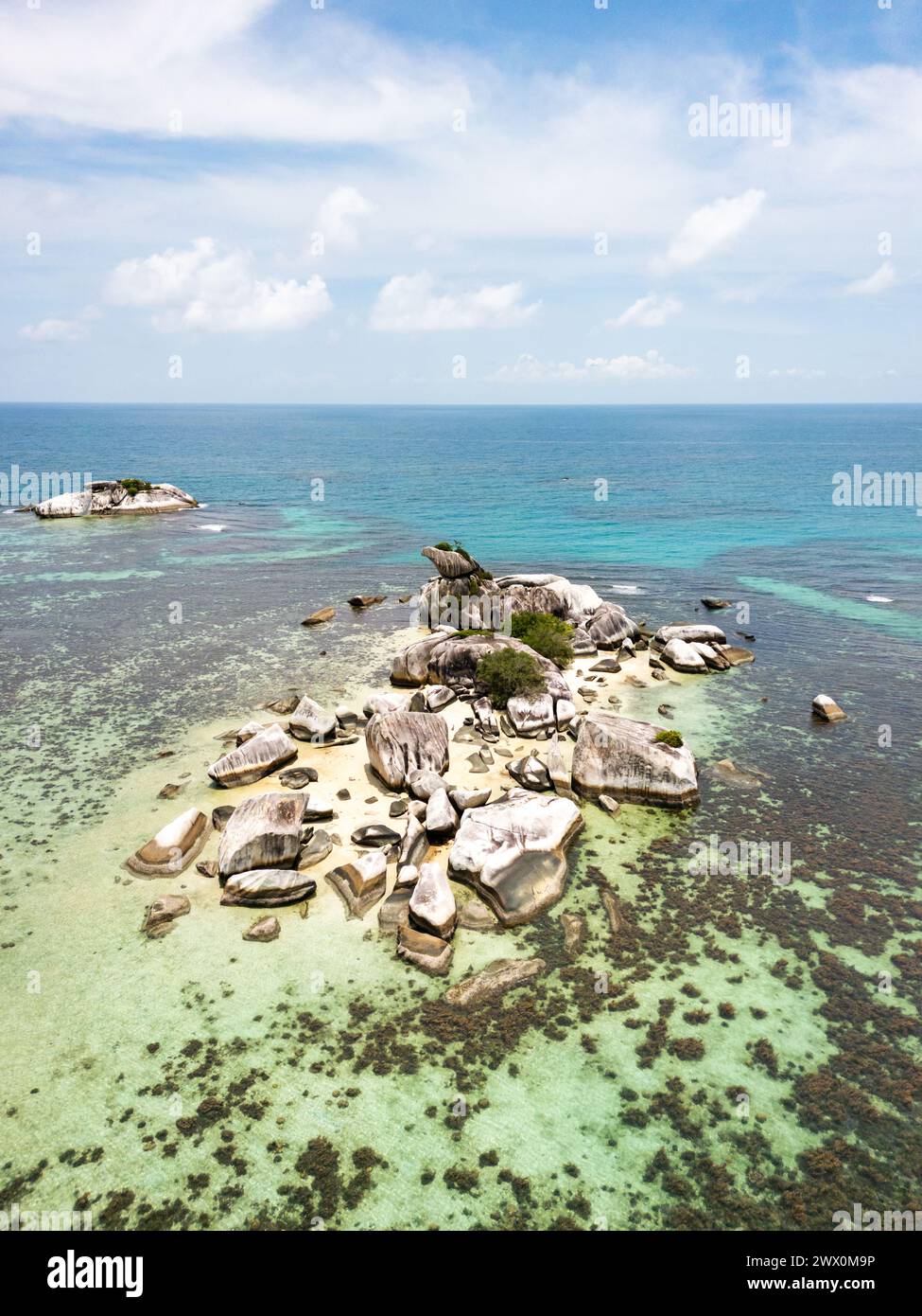 Belitung beach and islands drone view. Beautiful aerial view of islands, boat, sea and rocks in Belitung, Indonesia  Stock Photo