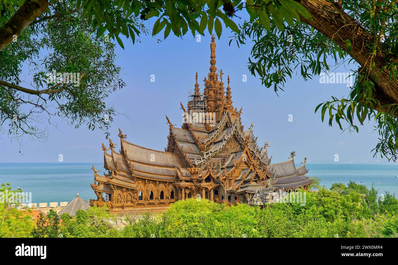 The Sanctuary of Truth Museum, the largest wooden building, temple, with carved wood features with blue sky, Chon Buri, Pattaya, Thailand Stock Photo