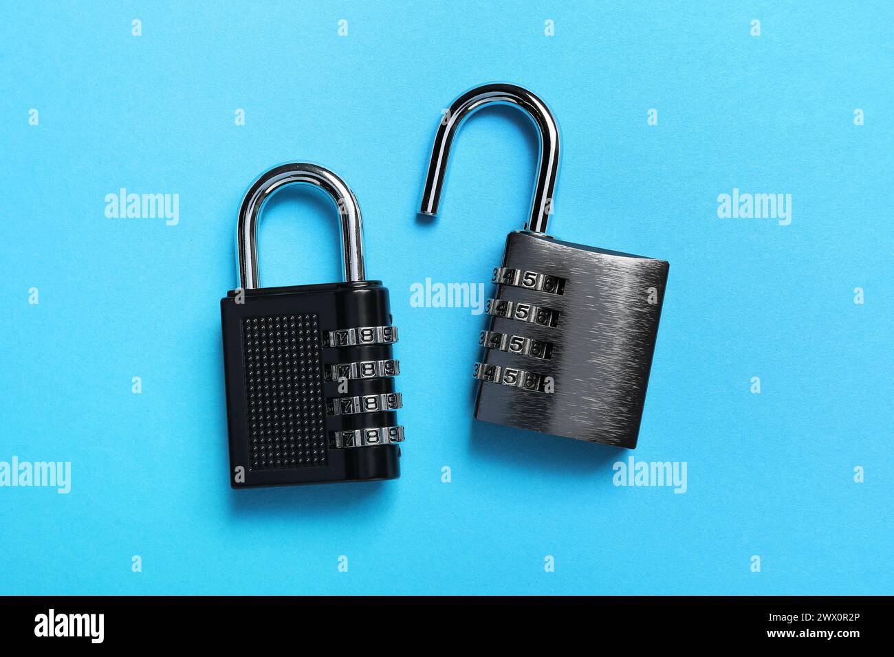 Steel combination padlocks on light blue background, top view Stock Photo