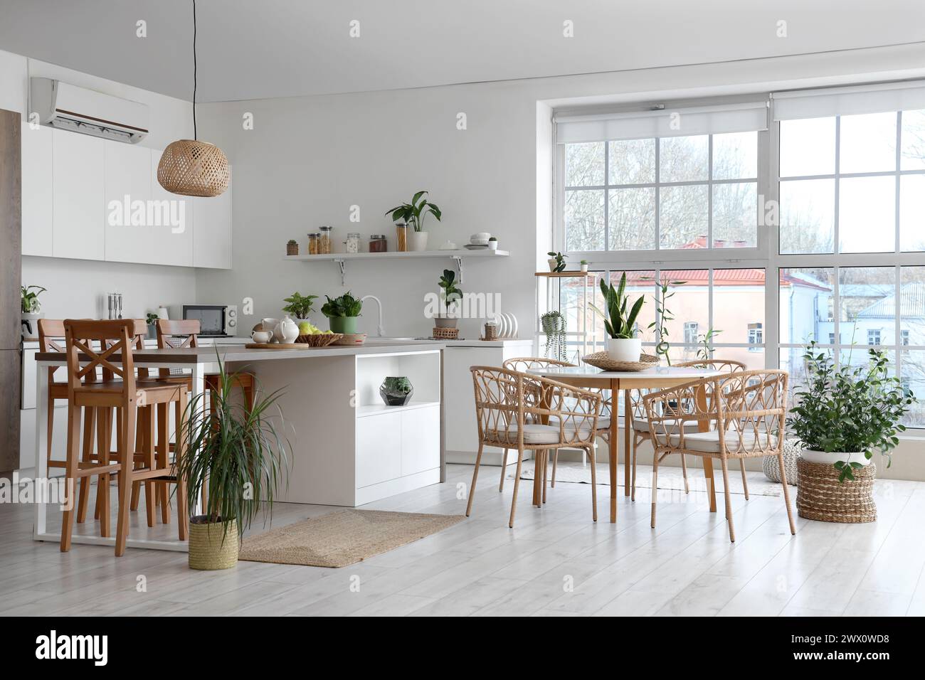 Stylish interior of modern kitchen with armchairs, dining table ...