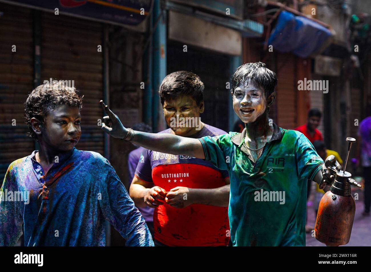 Dhaka, Bangladesh . 26th Mar, 2024. March 26, 2024, Dhaka, Bangladesh: Young people with silver painted faces take to the streets to celebrate the Dol Purnima festival know as Holi Festival at Sakhari Bazar. on March 26, 2024 in Dhaka, Bangladesh. (Photo by Nahid Hasan/ Eyepix Group/Sipa USA) Credit: Sipa USA/Alamy Live News Stock Photo