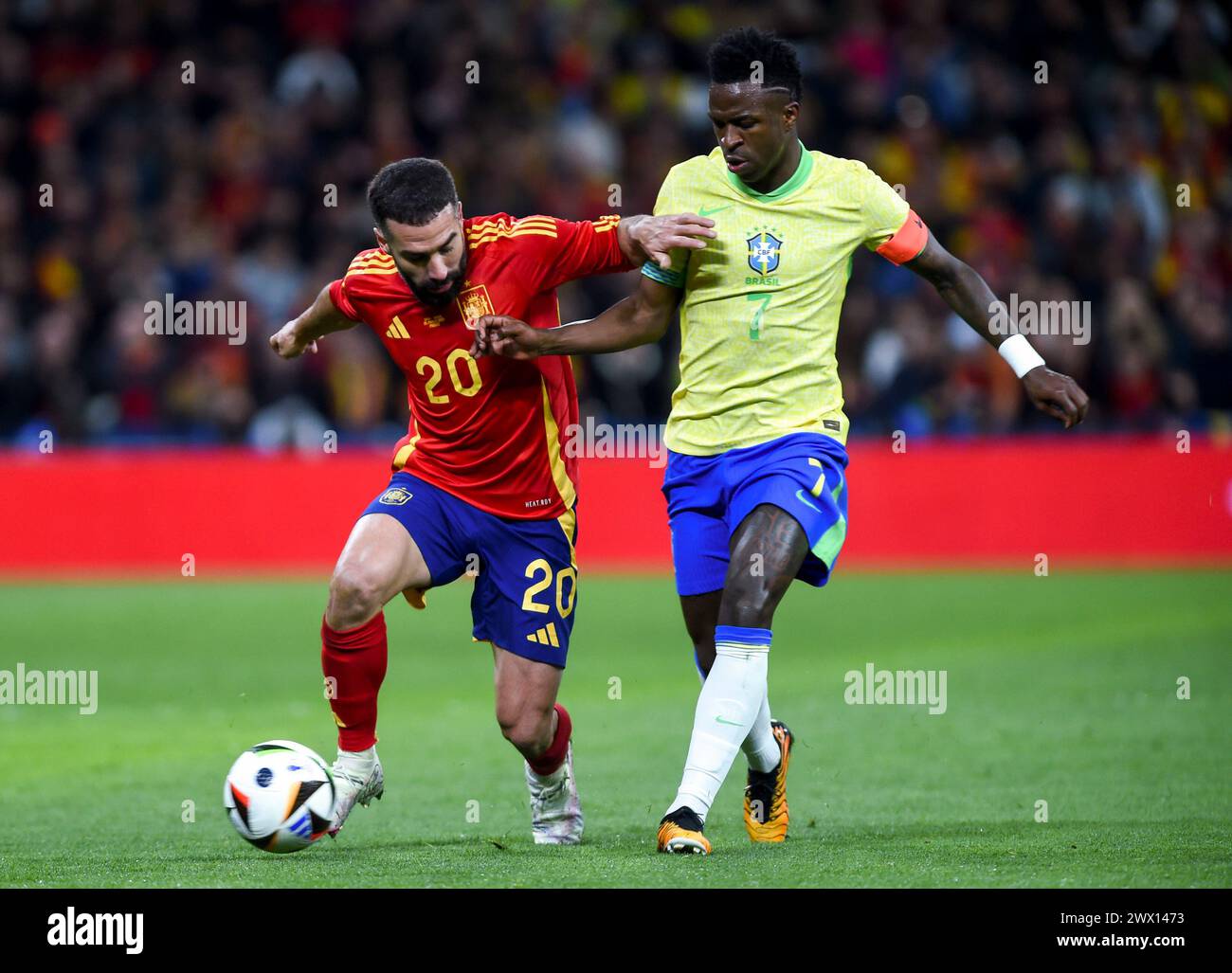 Madrid, Spain. 26th Mar, 2024. Spain's Daniel Carvajal (L) vies with Brazil's Vinicius Junior during an international friendly football match in Madrid, Spain, March 26, 2024. Credit: Gustavo Valiente/Xinhua/Alamy Live News Stock Photo