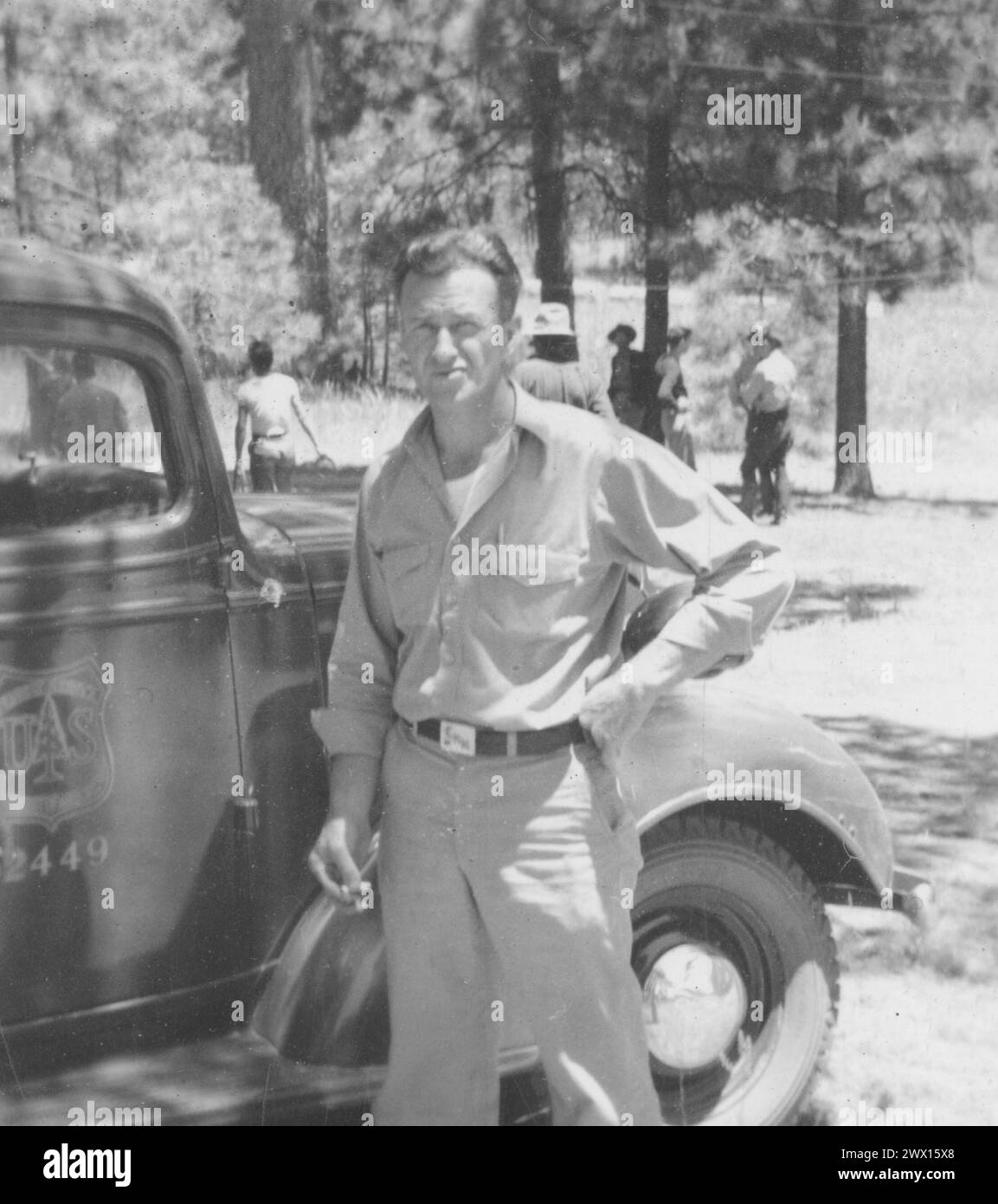 Photograph of a Man Standing Next to a U.S. Forest Service Vehicle ca