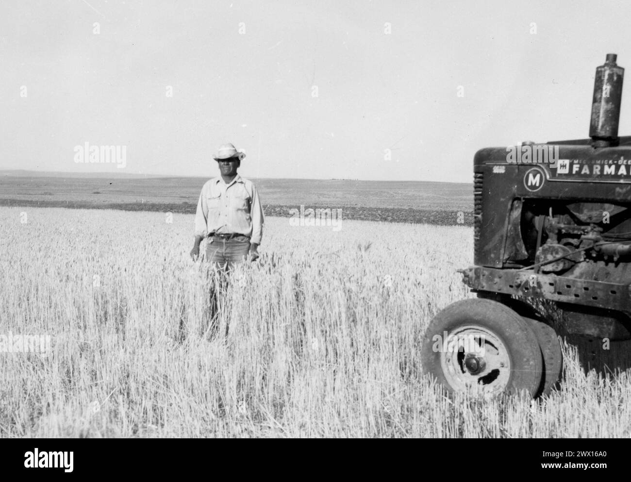 Man in Field in Wyoming with McCormick-Deering Farmall Tractor ca. 1934-1946 Stock Photo