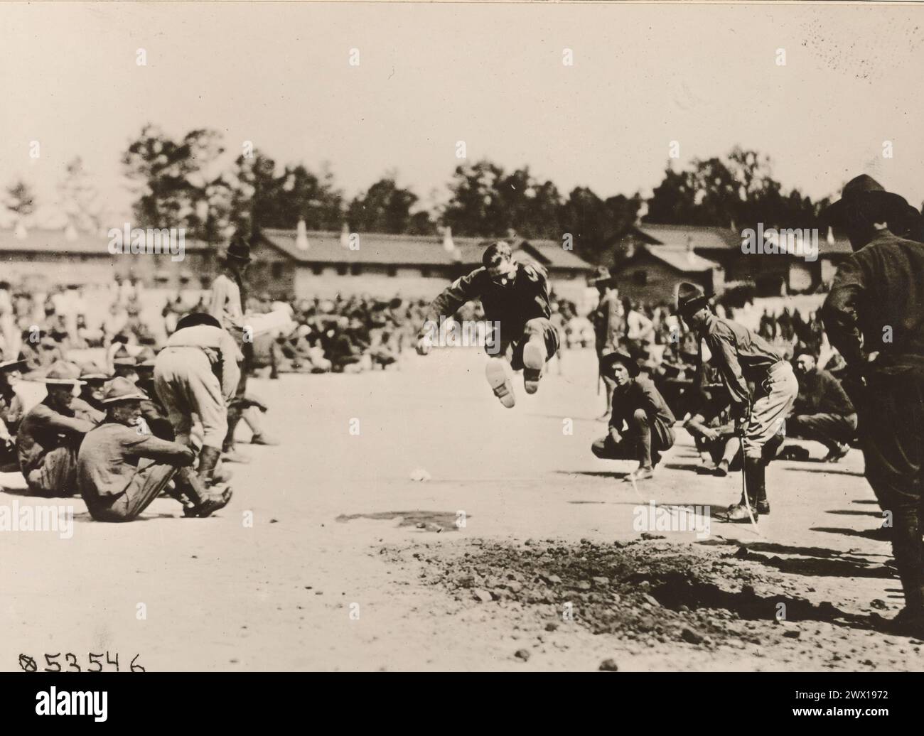 Soldiers at the U.S. School of Military Aeronautics, Ohio State College, Field Day Events, here, a soldier particpates in a long jump event ca. 1919 Stock Photo