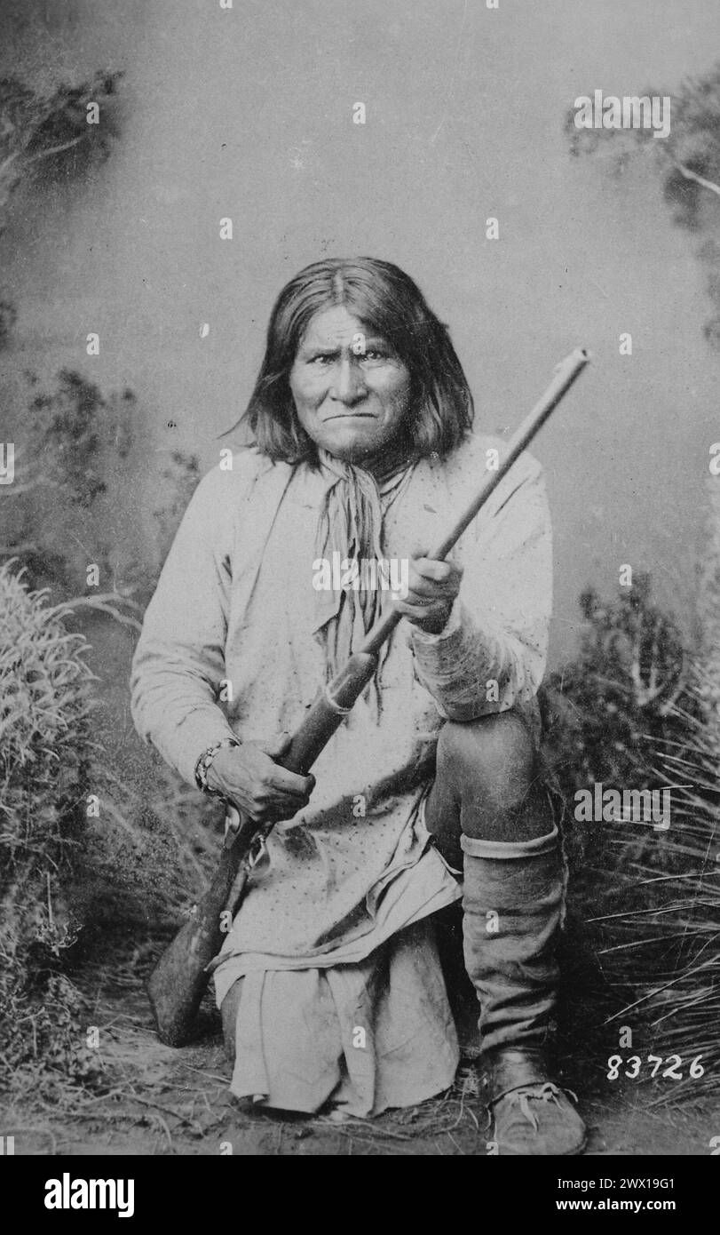 Geronimo (Goyathlay), a Chiricahua Apache; full-length, kneeling with ...