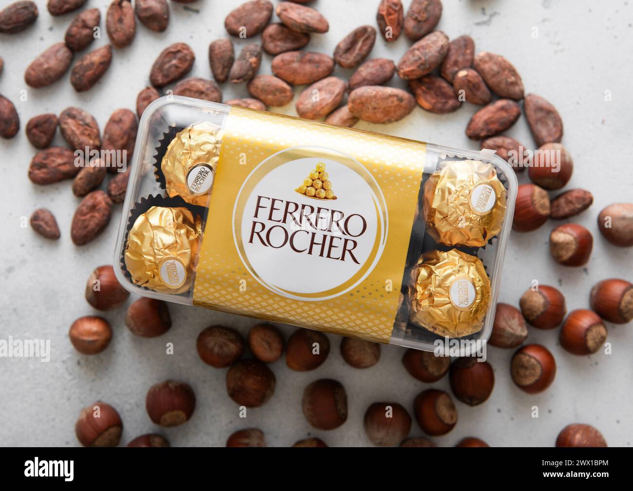 LONDON, UK - MARCH 10, 2024: Box of Ferrero Rocher chocolate candies with cocoa and hazelnut nuts. Stock Photo