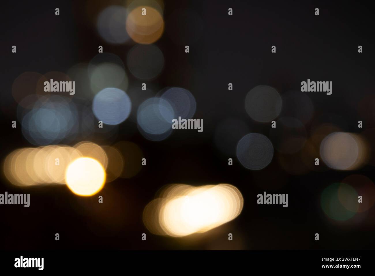 Blurred bokeh city lights, abstract night scene. Abstract high resolution full frame background with copy space. Stock Photo