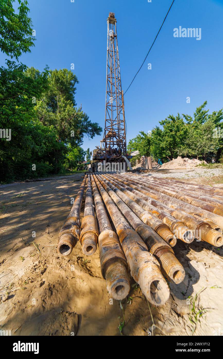 extension drilling rods in front of old water pump truck that extracts ...
