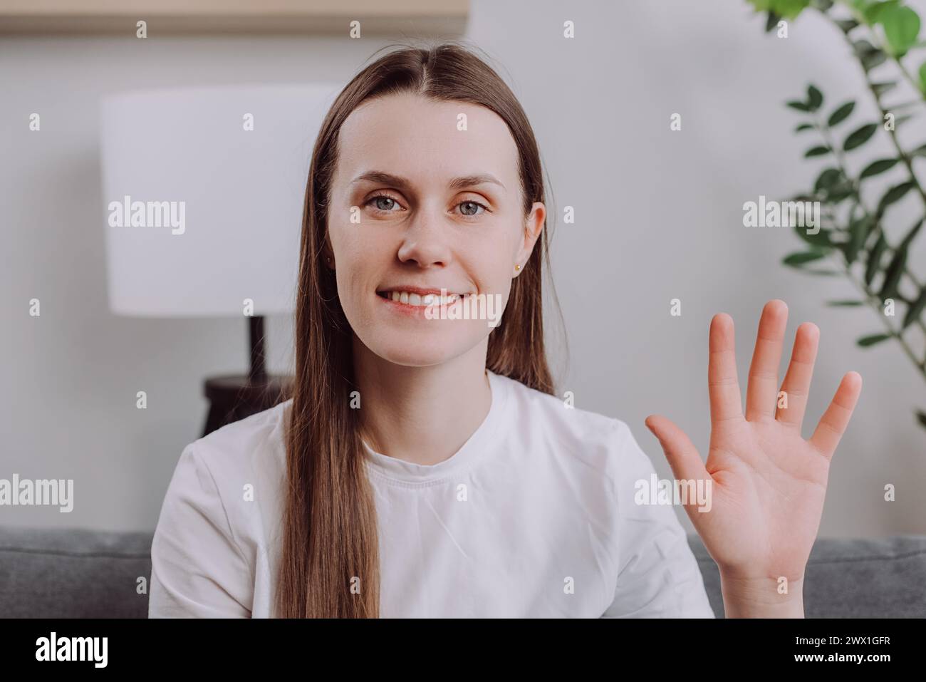Close up of smiling young woman looking at camera, enjoying video virtual meeting with friends or colleagues, distant communication, smiling charming Stock Photo