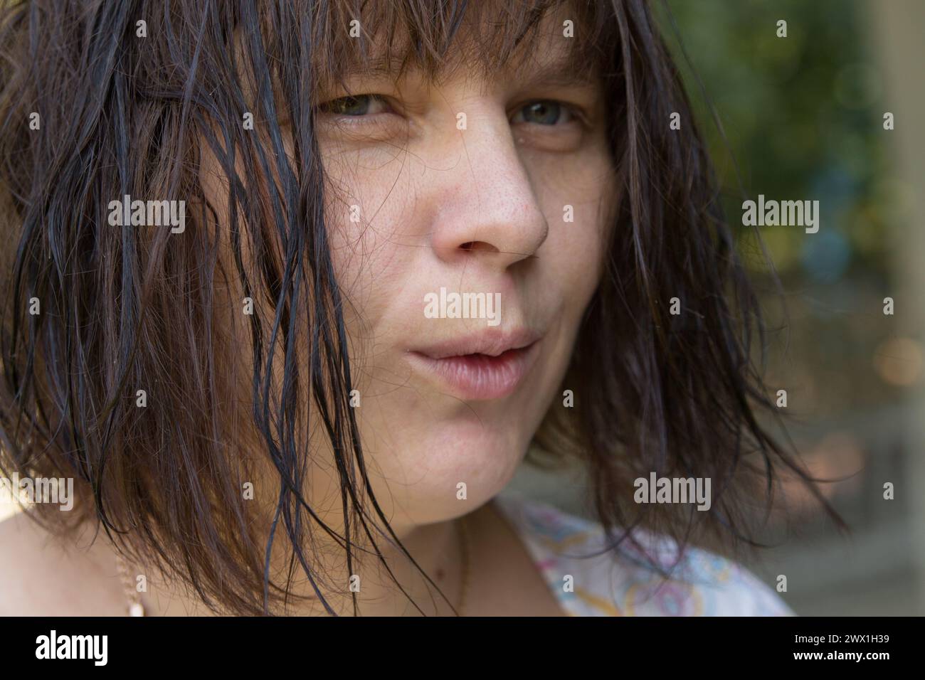 Close-up face of a woman with short wet hair in the nature Stock Photo