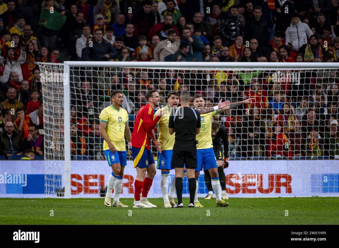 Madrid, Spain. 26th Mar, 2024. Brazilian players Danilo Da Silva, Lucas Paqueta and Bruno Guimaraes seen protesting with the referee during the friendly football match among the national teams of Spain and Brazil at Estadio Santiago Bernabeu, Madrid. Credit: Independent Photo Agency/Alamy Live News Stock Photo