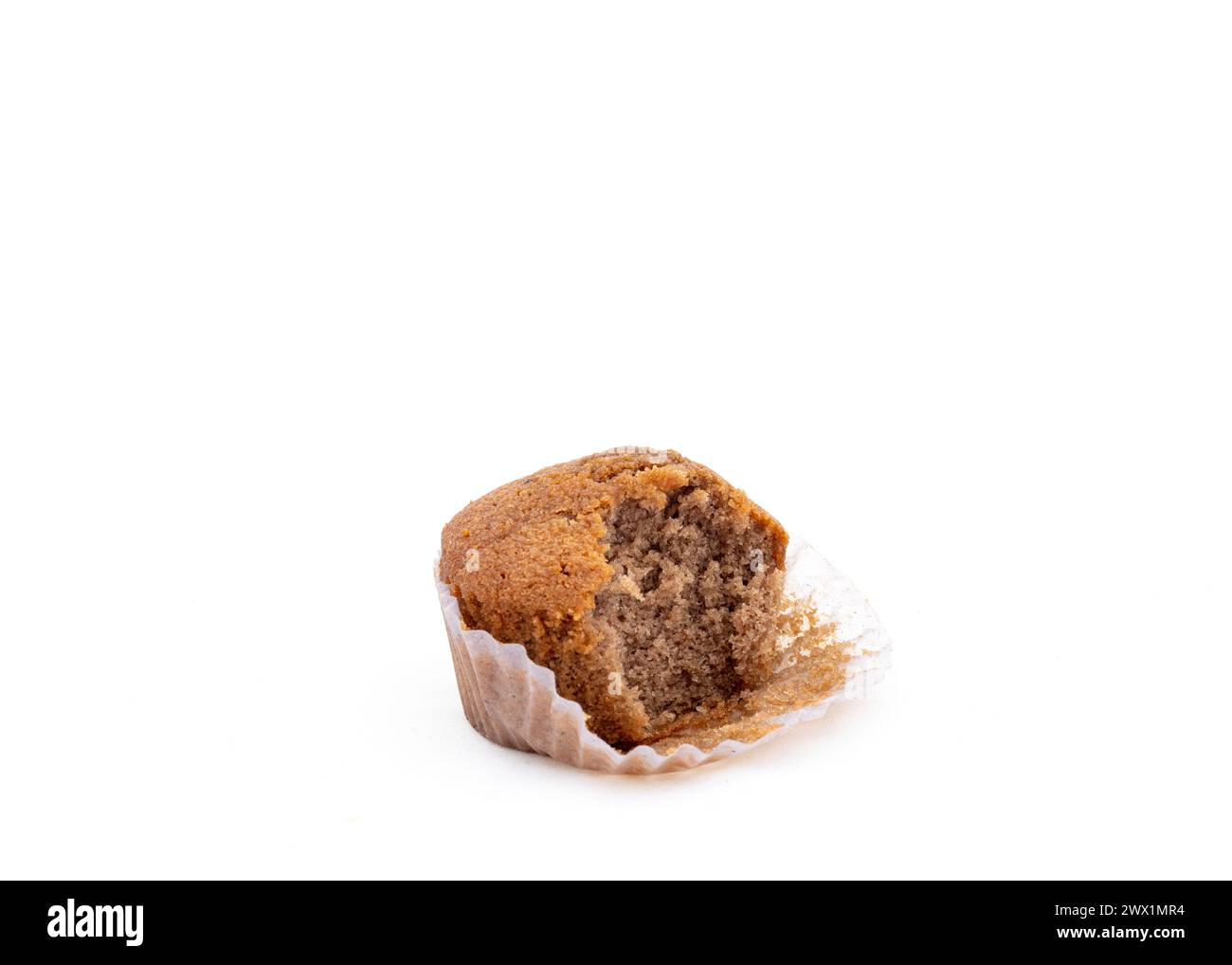 Cupcake with a bite eaten out from it on a white isolated background Stock Photo