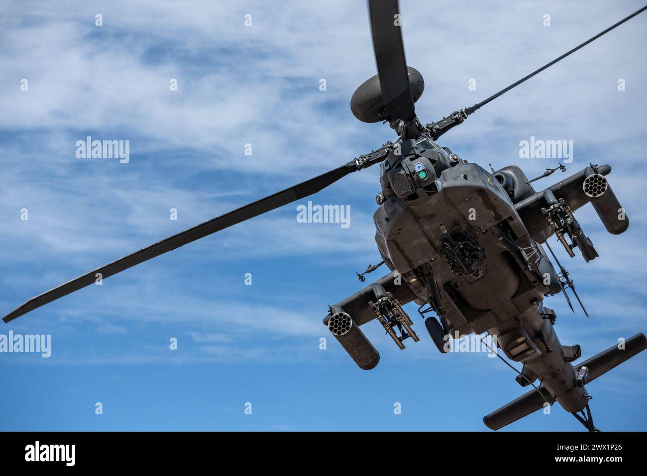 An AH-64 Apache from the 3rd Squadron, 6th Cavalry, 1st Armored Division Combat Aviation Brigade flies overhead during Operation Sandlot Stock Photo