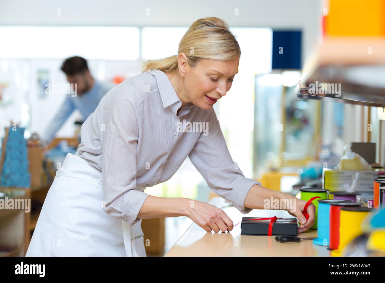 Woman wrapping present roll tape hi-res stock photography and images ...