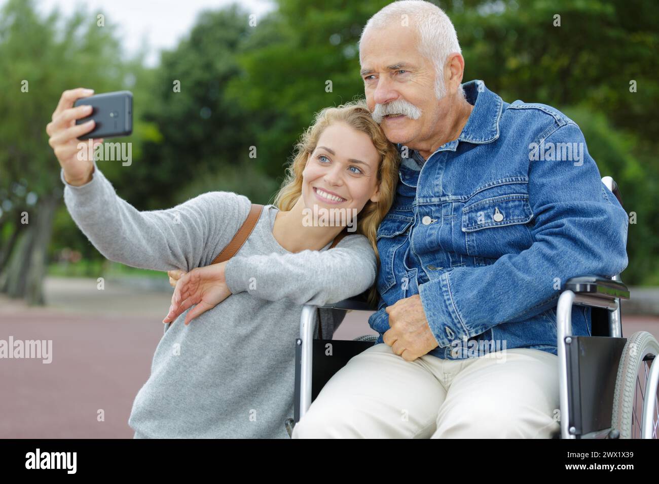 elderly man in wheelchair taking selfie with his daughter Stock Photo ...