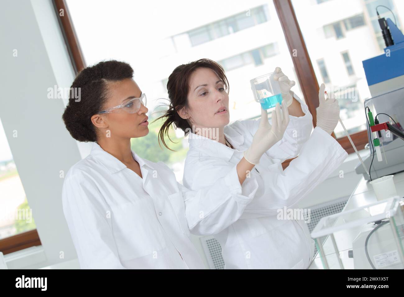 two young female scientist doing experiments in lab Stock Photo